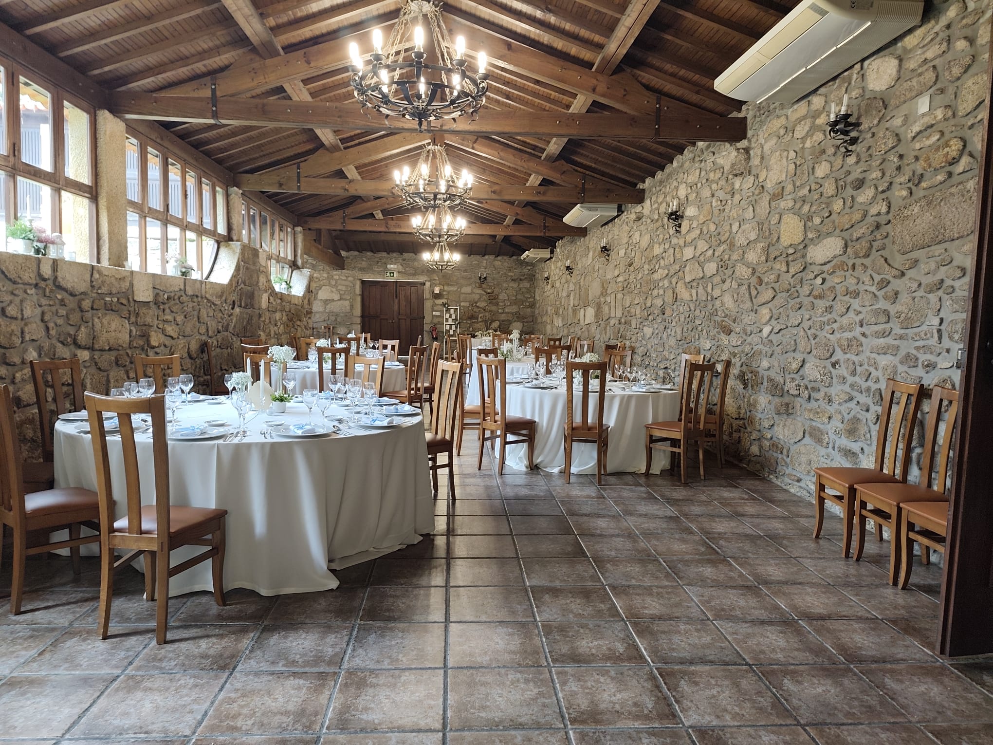 Salão Principal da Quinta do Coelho — teto de madeira e paredes de pedra